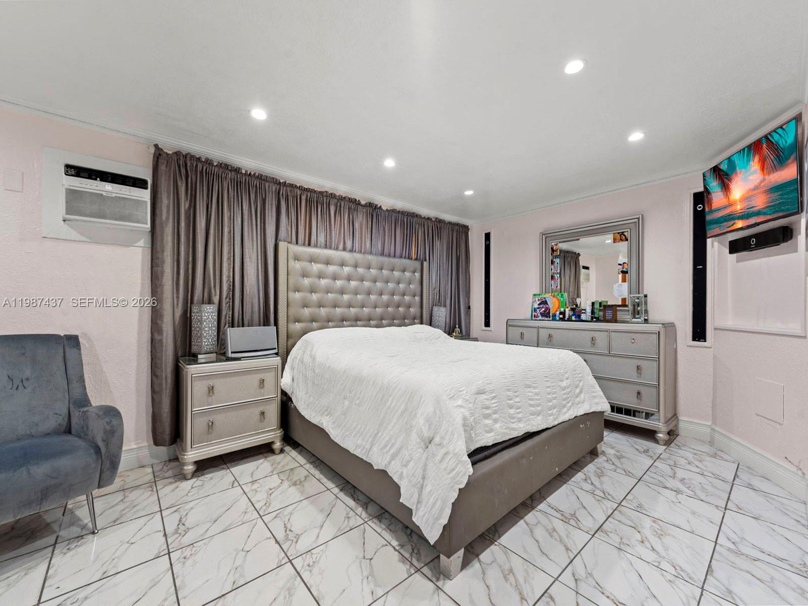 871 Southeast 5th Place Hialeah, FL 33010 - Photo 18 of 39 a bedroom with a bed and a couch