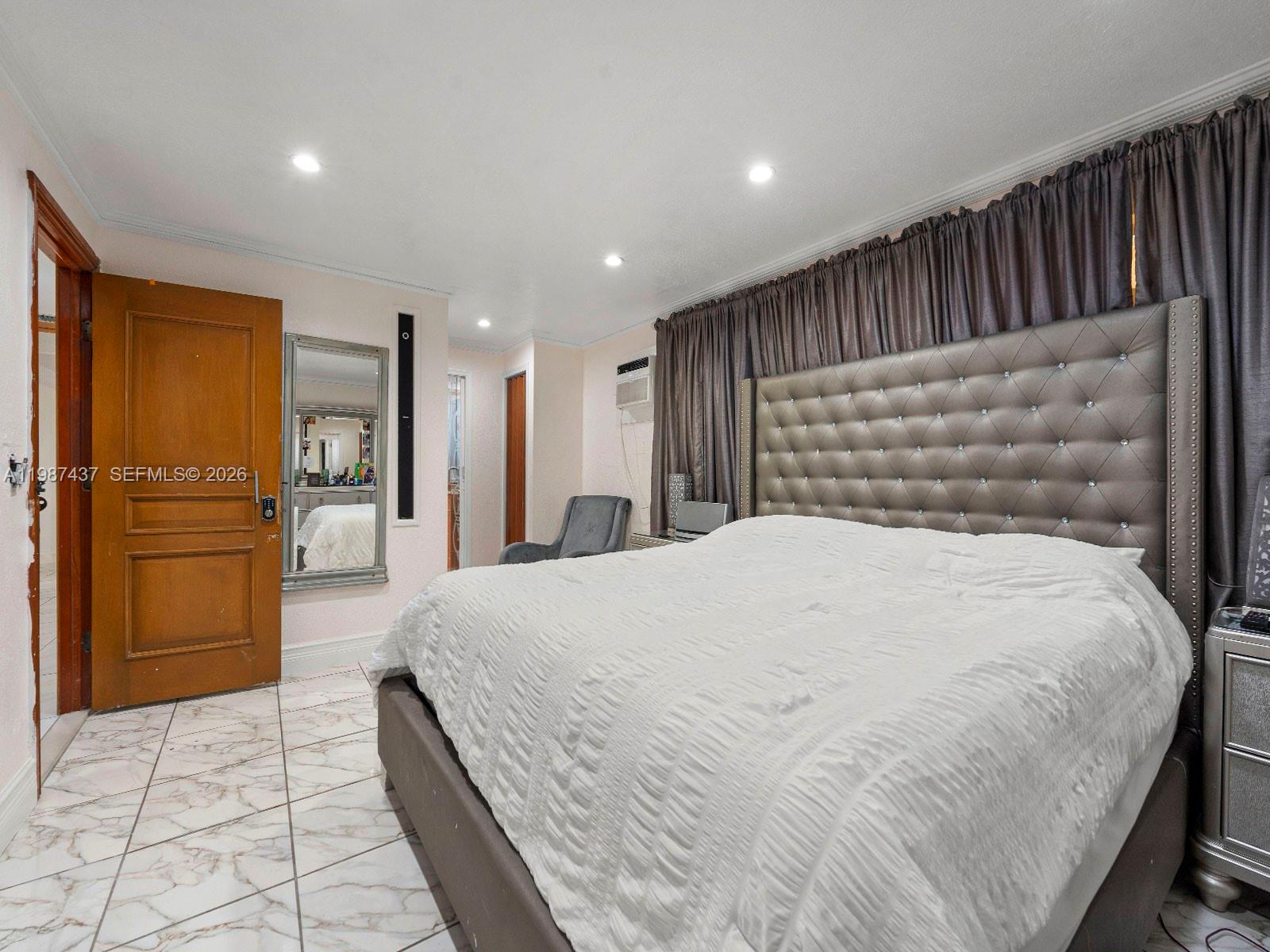 871 Southeast 5th Place Hialeah, FL 33010 - Photo 19 of 39 a spacious bedroom with a bed and a refrigerator