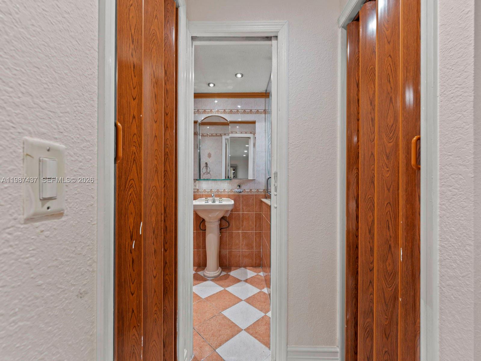 871 Southeast 5th Place Hialeah, FL 33010 - Photo 20 of 39 a bathroom with a sink and a mirror