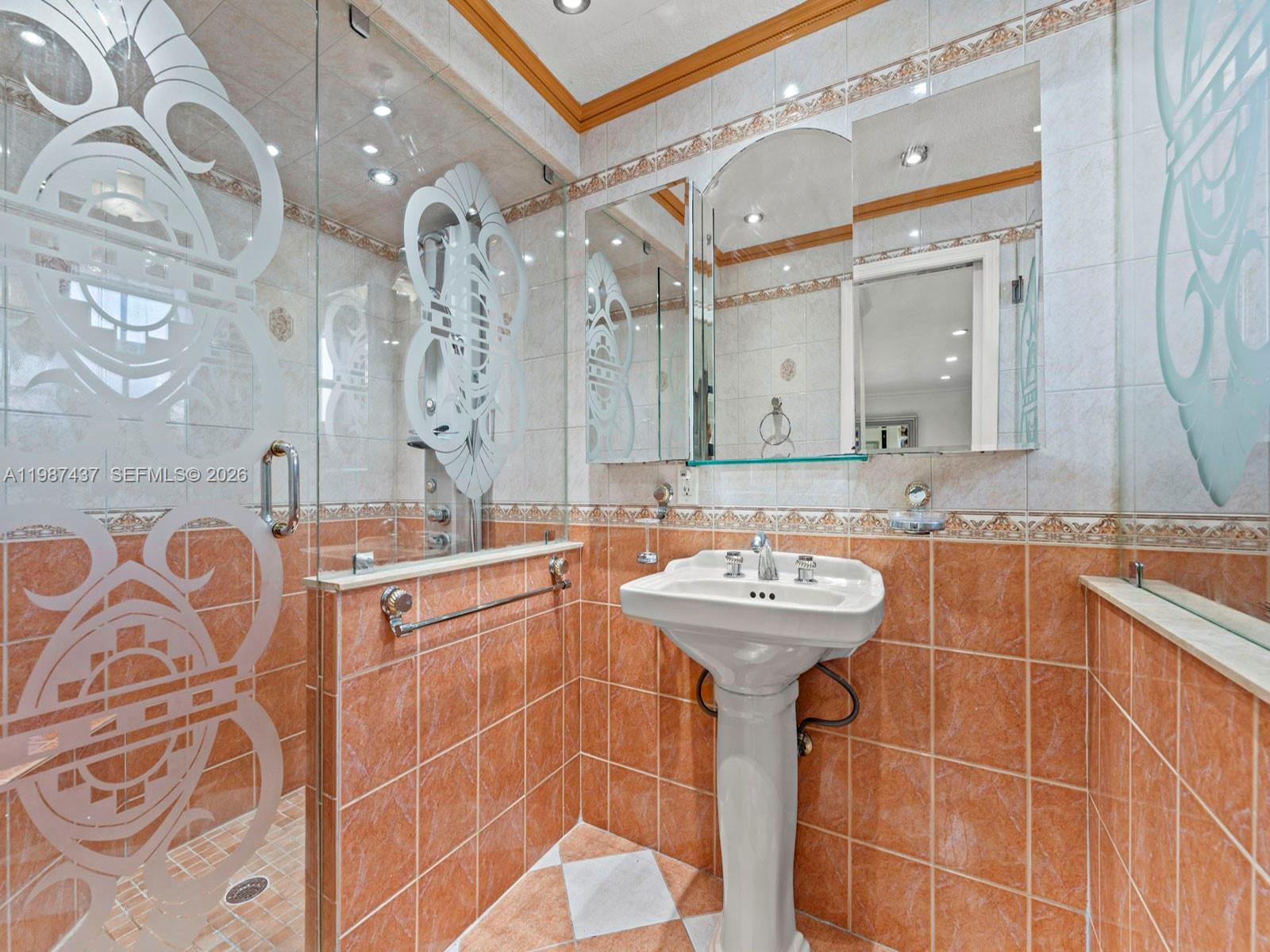 871 Southeast 5th Place Hialeah, FL 33010 - Photo 22 of 39 a bathroom with a sink a mirror and a shower