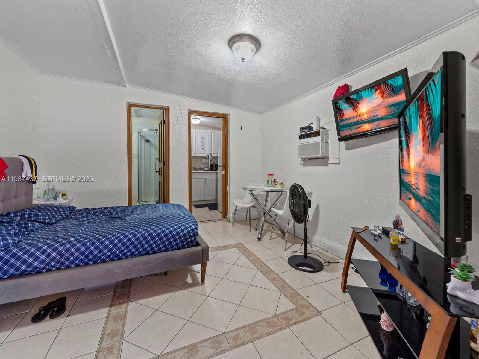 871 Southeast 5th Place Hialeah, FL 33010 - Photo 27 of 39 a bedroom with furniture and a flat screen tv