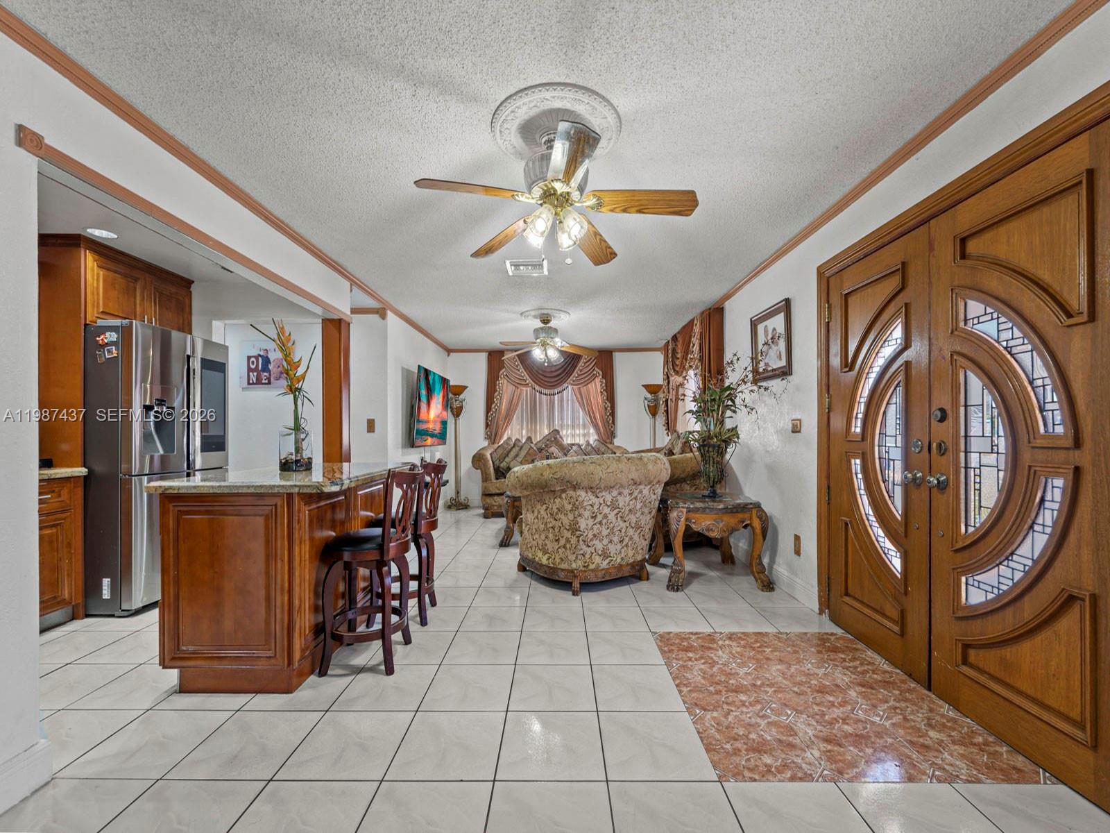 871 Southeast 5th Place Hialeah, FL 33010 - Photo 10 of 39 a living room with furniture and a chandelier