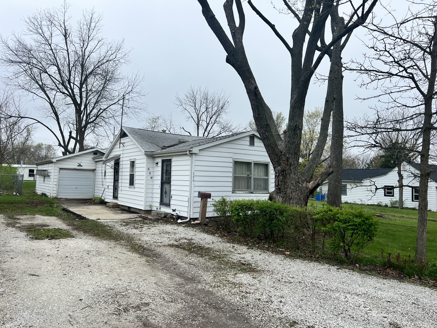 356 East Fulton Street Paxton, IL 60957 - Photo 1 of 25 a front view of a house with a yard and tree s