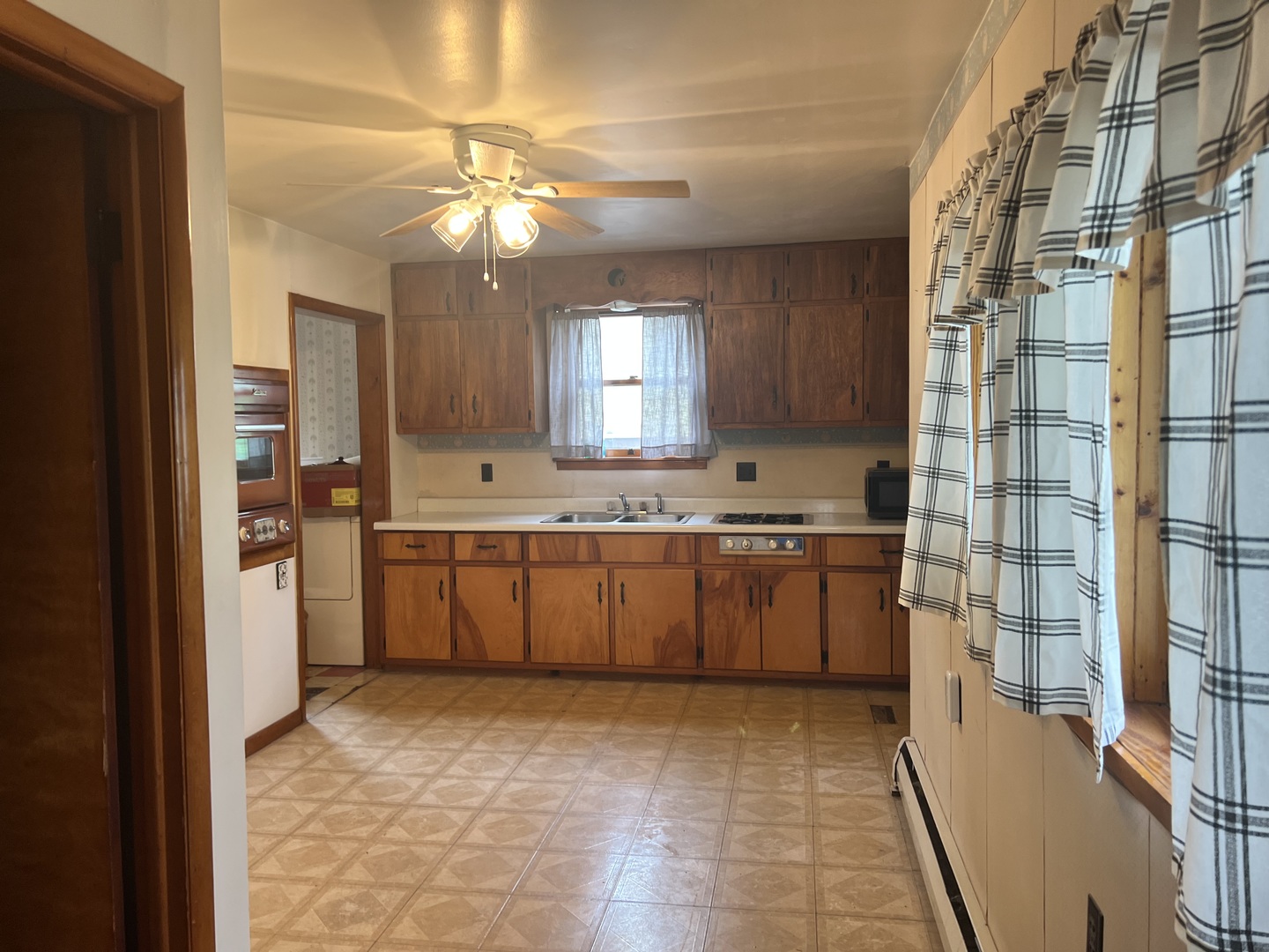 356 East Fulton Street Paxton, IL 60957 - Photo 23 of 25 a kitchen with a sink window and cabinets