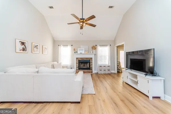 a living room with furniture and a flat screen tv