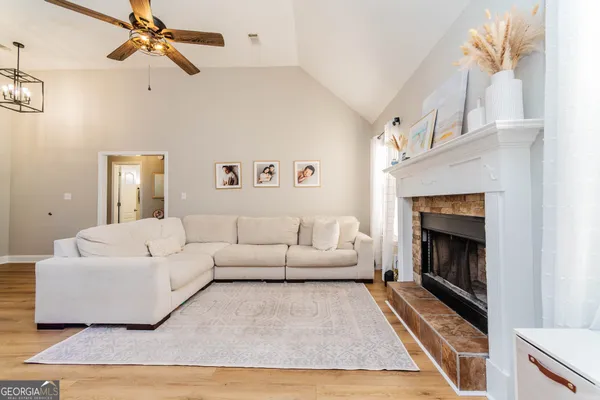 a living room with furniture and a fireplace
