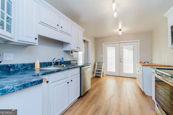 a kitchen with granite countertop a stove and a sink