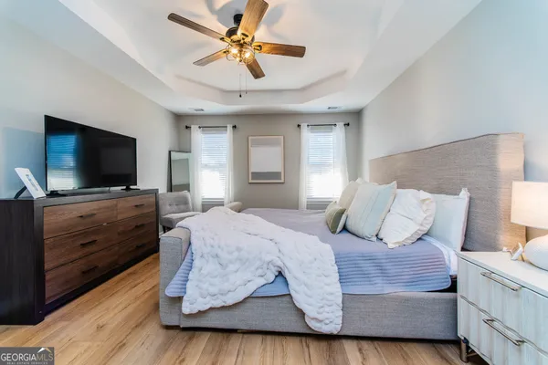 a bedroom with a large bed and a flat screen tv