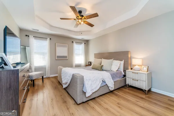 a bedroom with a bed and a large window
