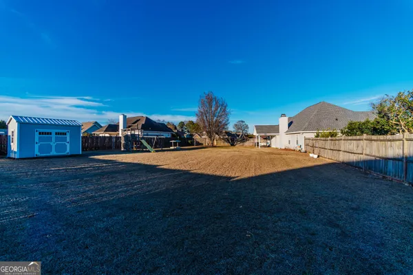 a view of house with outdoor space and garden