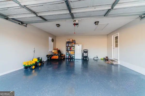 a garage with furniture and a ceiling fan