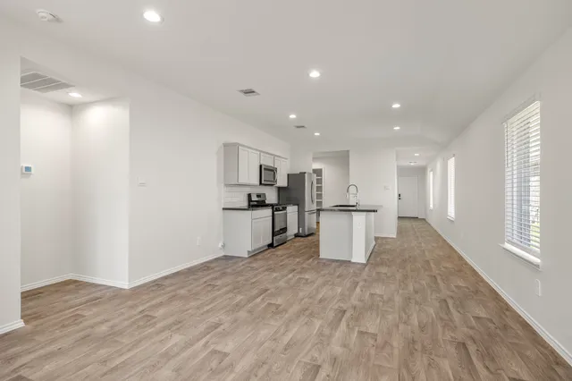 a view of kitchen with wooden floor