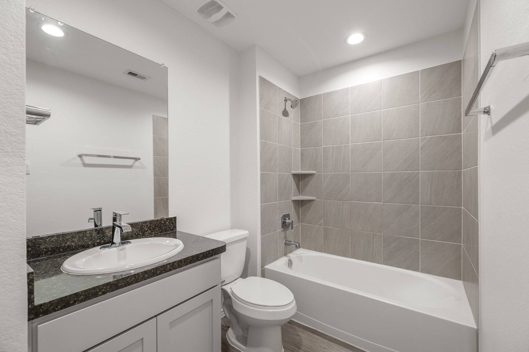 5402 Auburn Gardens Court Spring, TX 77373 - Photo 19 of 31 a bathroom with a bath tub sink mirror vanity and toilet