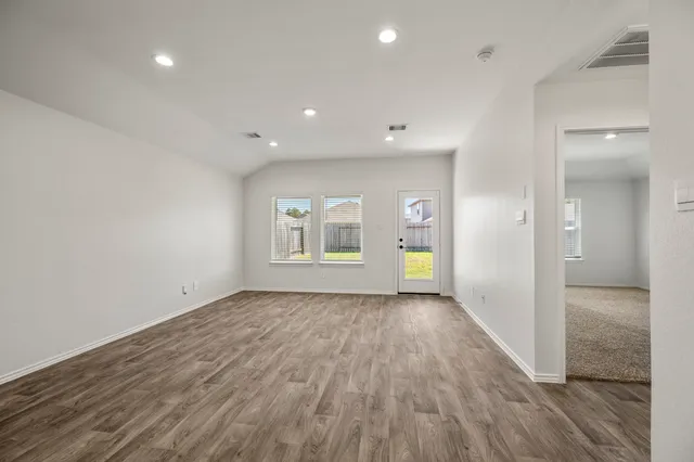wooden floor in an empty room with a window