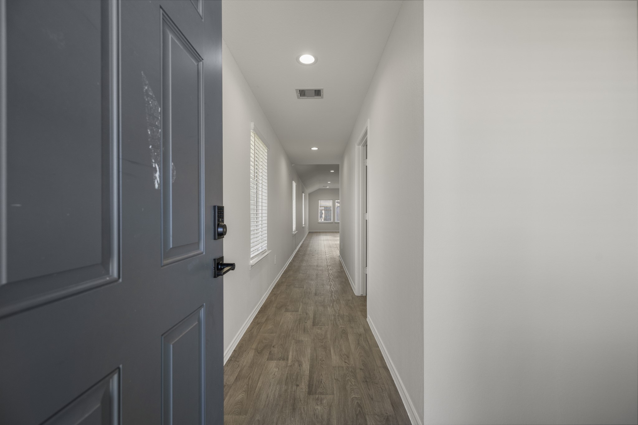 5402 Auburn Gardens Court Spring, TX 77373 - Photo 5 of 31 a view of a hallway with wooden floor and staircase