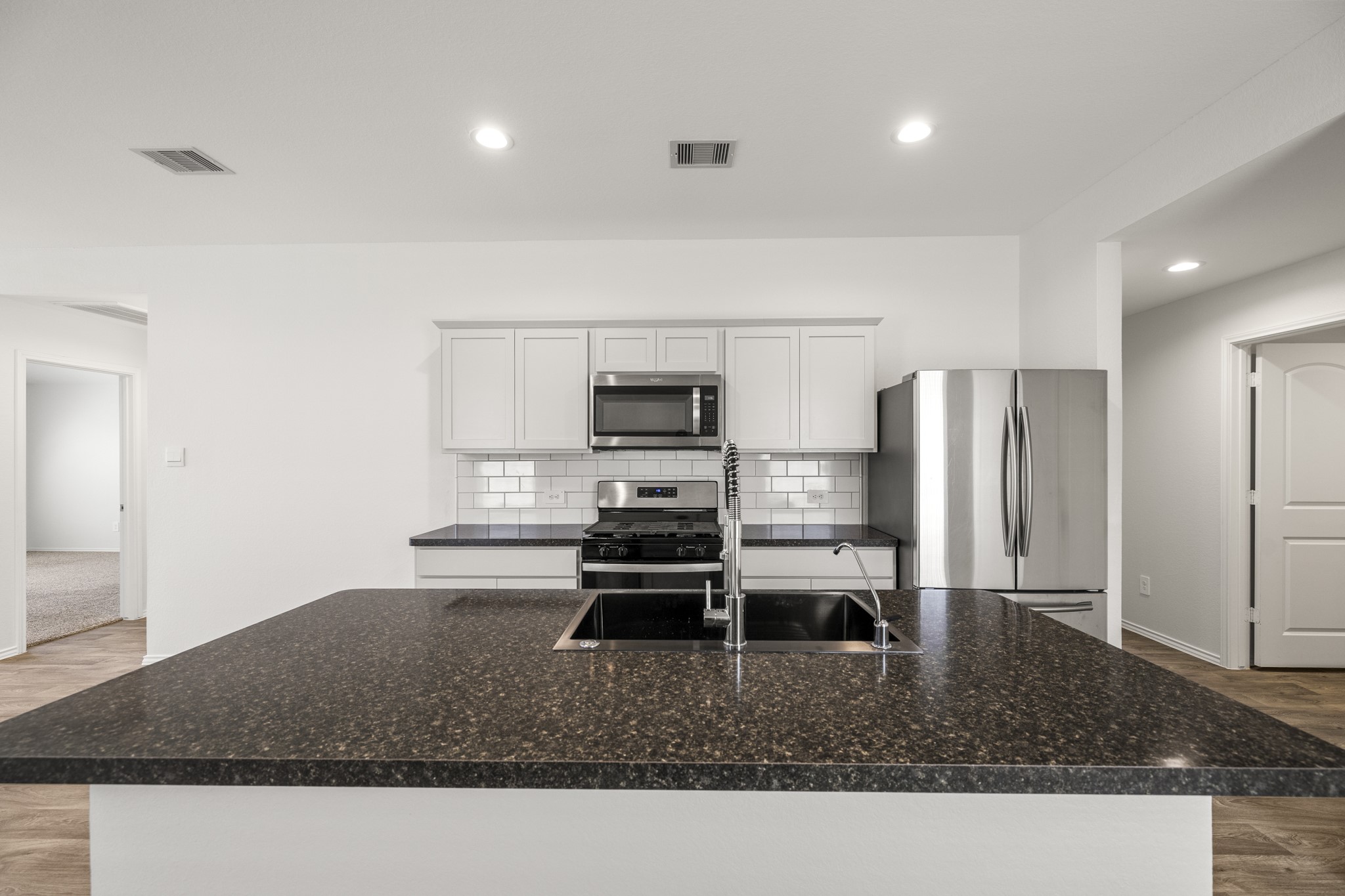 5402 Auburn Gardens Court Spring, TX 77373 - Photo 9 of 31 a kitchen with a sink stainless steel appliances and cabinets