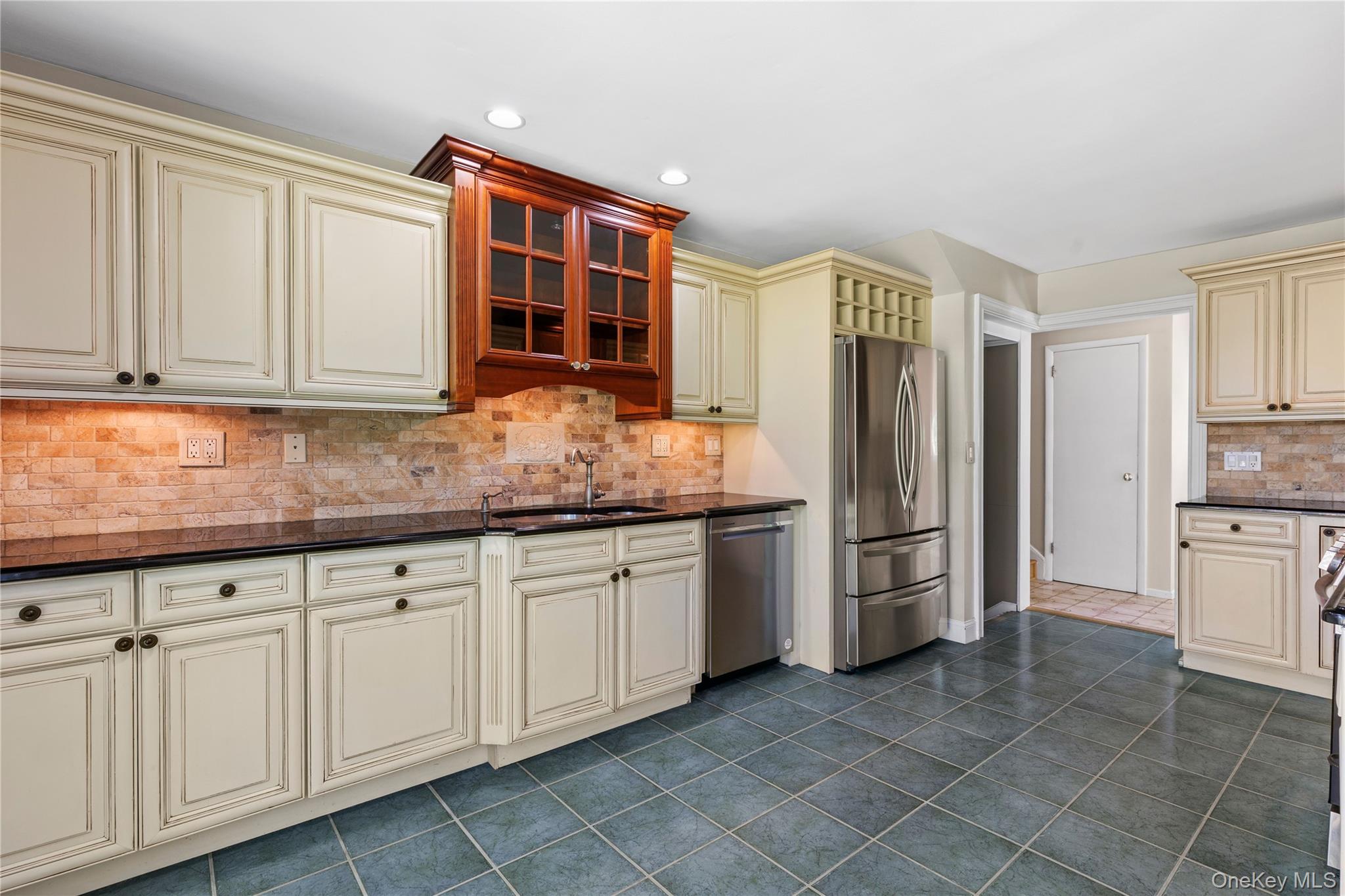 4 Mark Drive Rye Brook, NY 10573 - Photo 13 of 47 Kitchen featuring cream cabinets, tasteful backsplash, dark tile patterned floors, stainless steel appliances, and recessed lighting