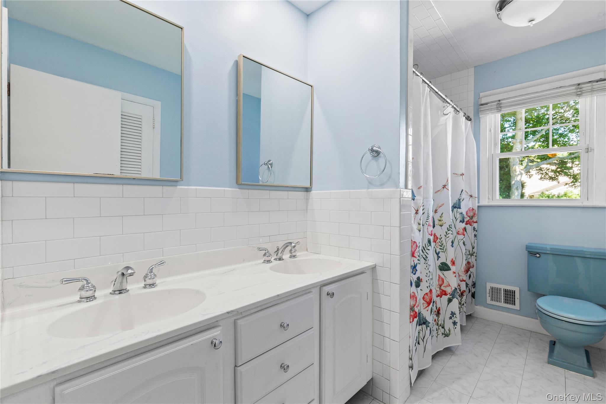 4 Mark Drive Rye Brook, NY 10573 - Photo 15 of 47 Bathroom with tile walls, double vanity, and a shower with curtain