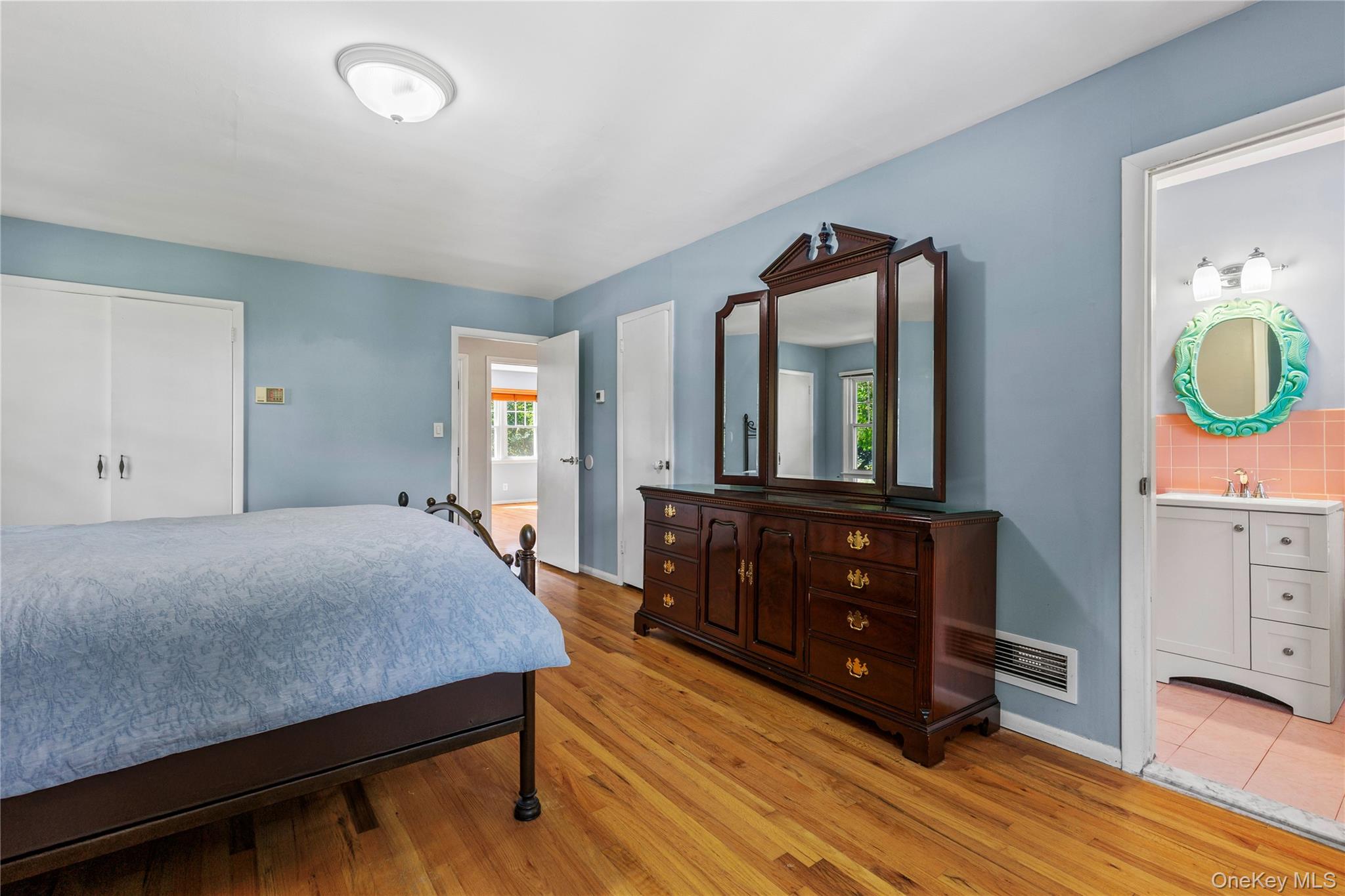 4 Mark Drive Rye Brook, NY 10573 - Photo 17 of 47 Bedroom featuring light wood-type flooring, a closet, and ensuite bathroom