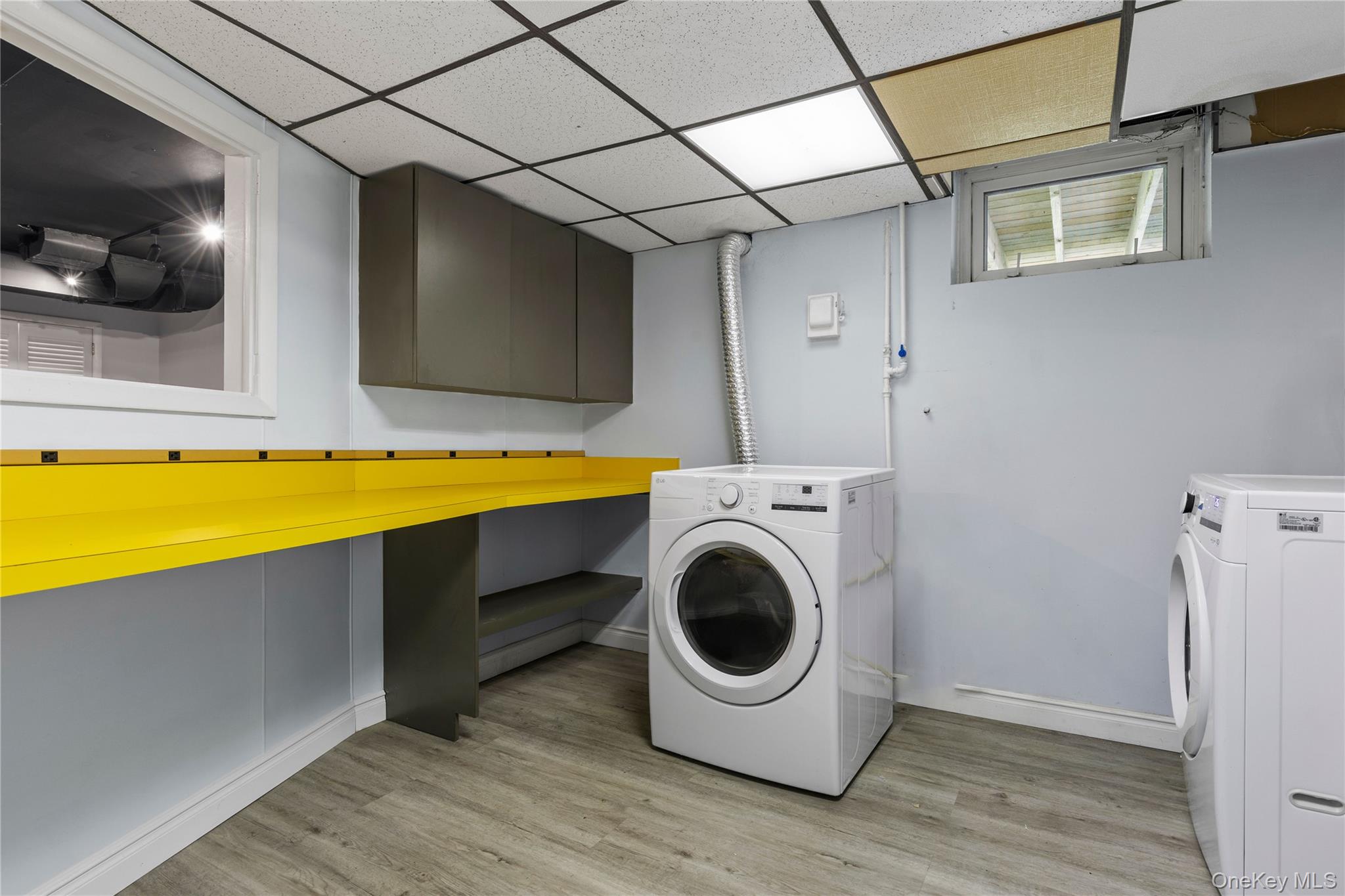 4 Mark Drive Rye Brook, NY 10573 - Photo 30 of 47 Laundry room with light wood-type flooring, washer and dryer, and cabinet space