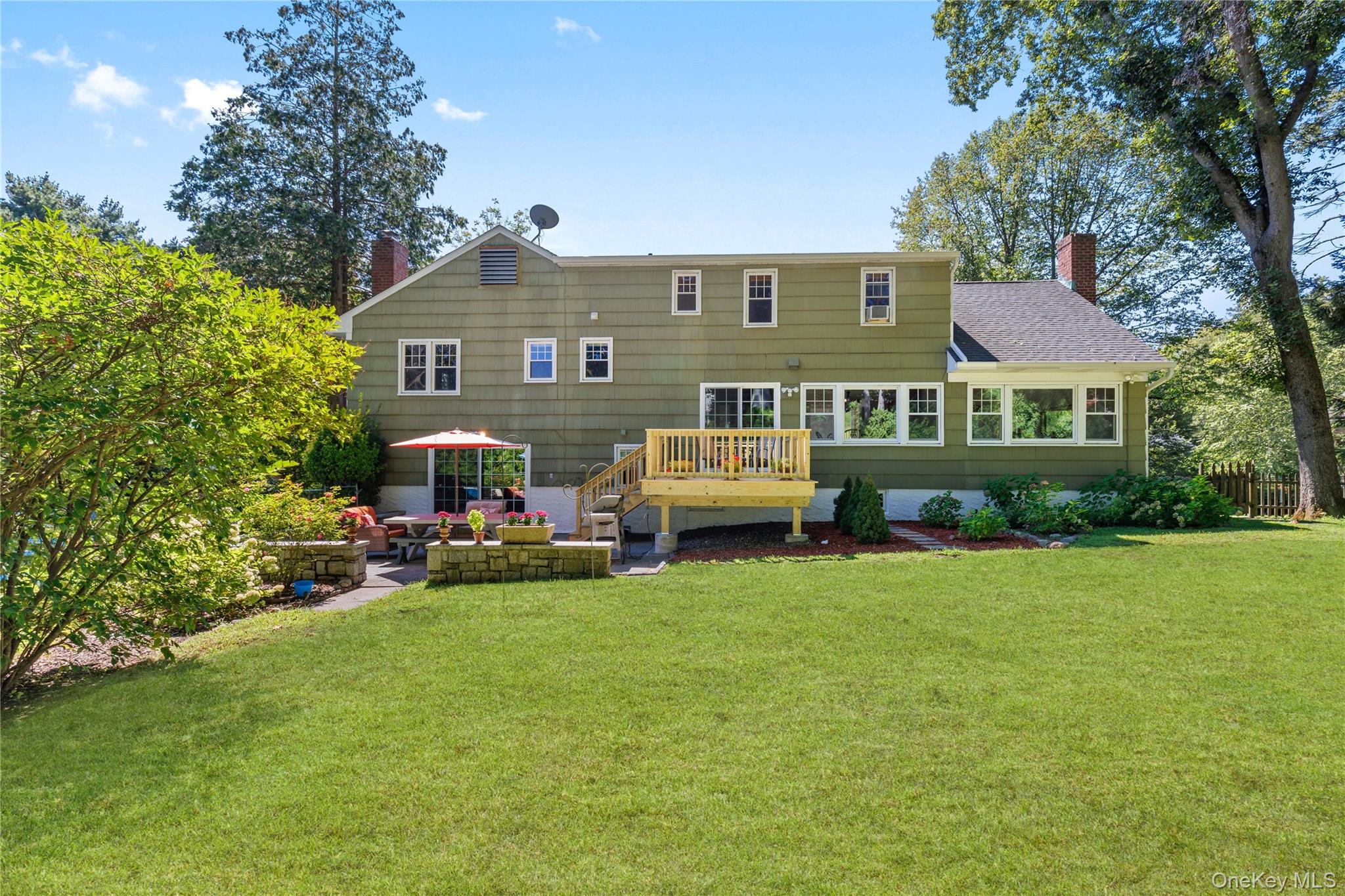 4 Mark Drive Rye Brook, NY 10573 - Photo 34 of 47 Rear view of house featuring a chimney, a patio area, a lawn, and roof with shingles