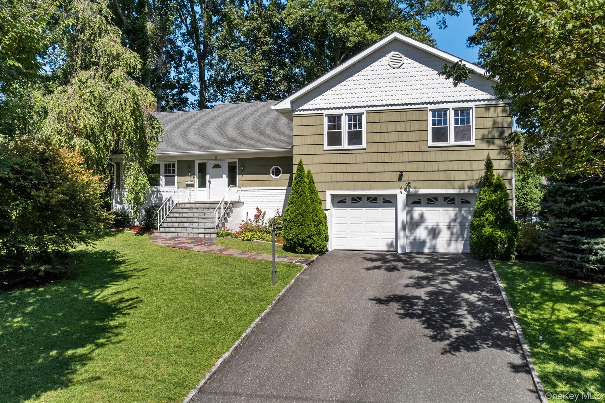 4 Mark Drive Rye Brook, NY 10573 - Photo 41 of 47 Tri-level home with driveway, a front lawn, and a garage