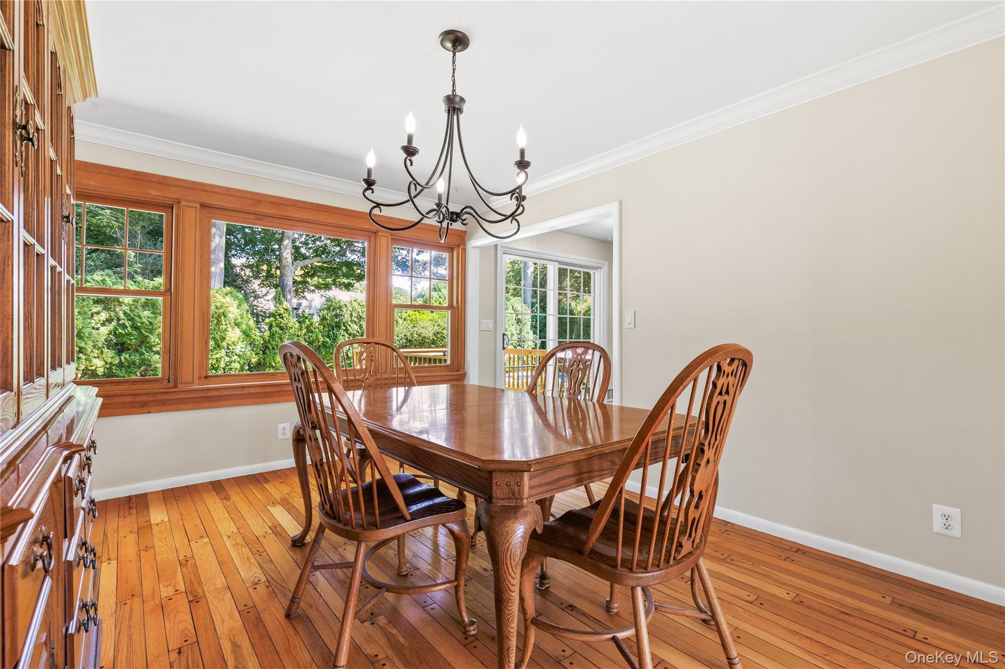 4 Mark Drive Rye Brook, NY 10573 - Photo 8 of 47 Dining area featuring crown molding, light wood finished floors, and a chandelier