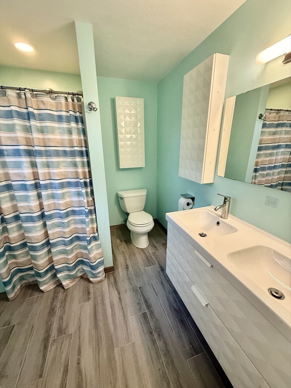 19 Fairview Road, Unit A Framingham, MA 01702 - Photo 12 of 28 a bathroom with a sink a mirror and a toilet