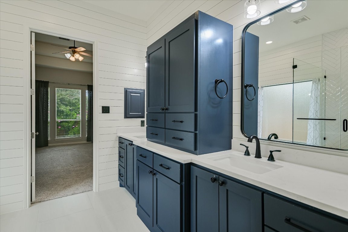 1911 Misty Ridge Leander, TX 78641 - Photo 13 of 30 a bathroom with a double vanity sink and a mirror