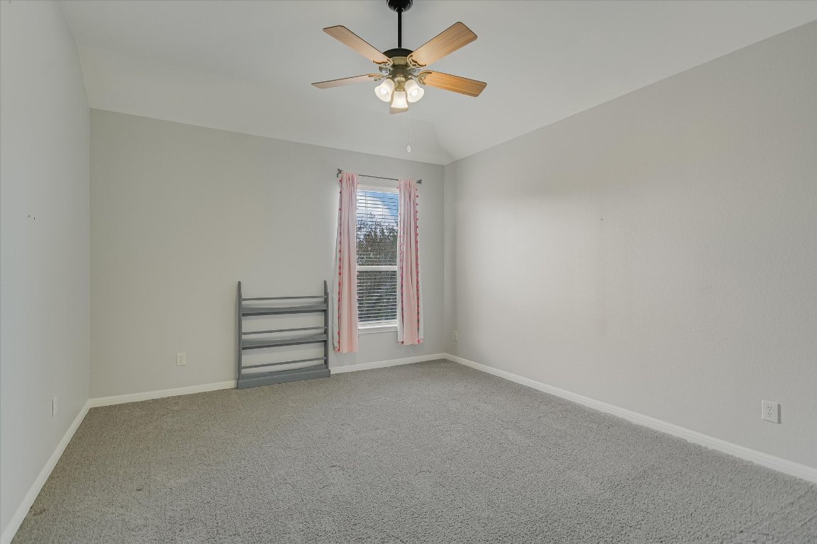 1911 Misty Ridge Leander, TX 78641 - Photo 23 of 30 an empty room with a ceiling fan and window