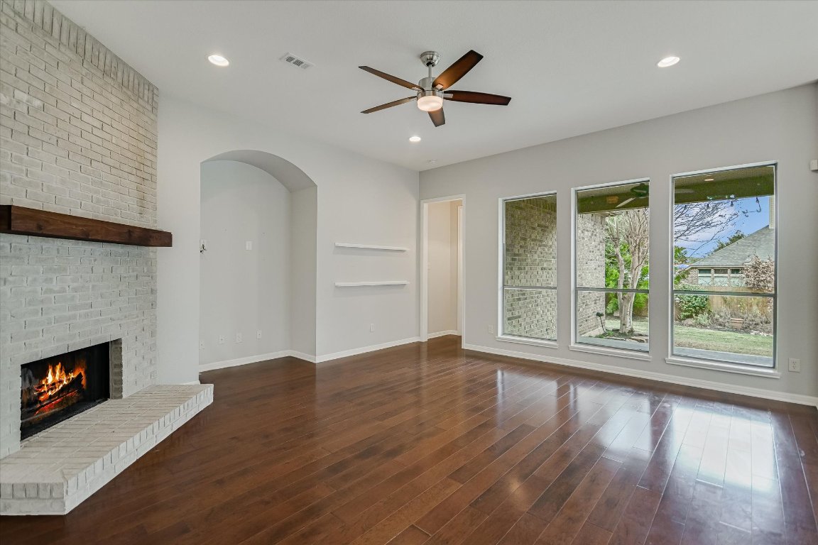 1911 Misty Ridge Leander, TX 78641 - Photo 6 of 30 a view of an empty room with wooden floor and a window