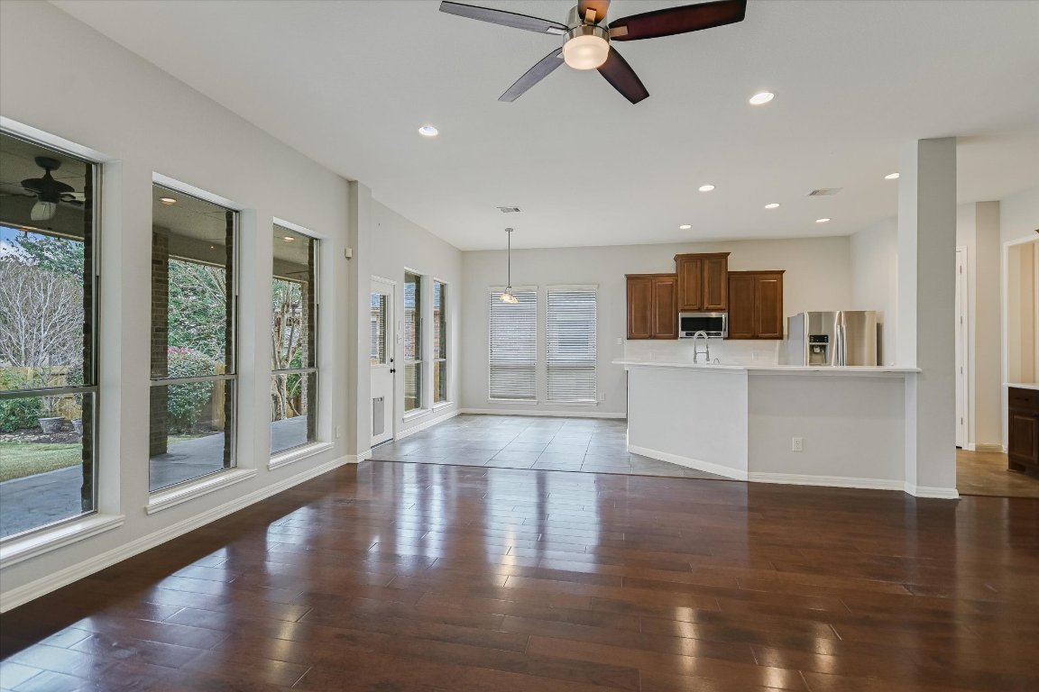 1911 Misty Ridge Leander, TX 78641 - Photo 7 of 30 a view of a kitchen with a kitchen island wooden floor and a window