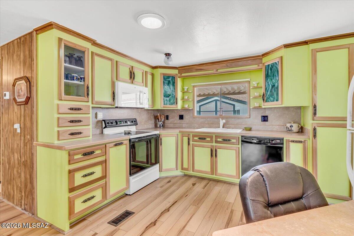5840 West Flying W Street Tucson, AZ 85713 - Photo 6 of 38 a kitchen with stainless steel appliances granite countertop a stove and a sink