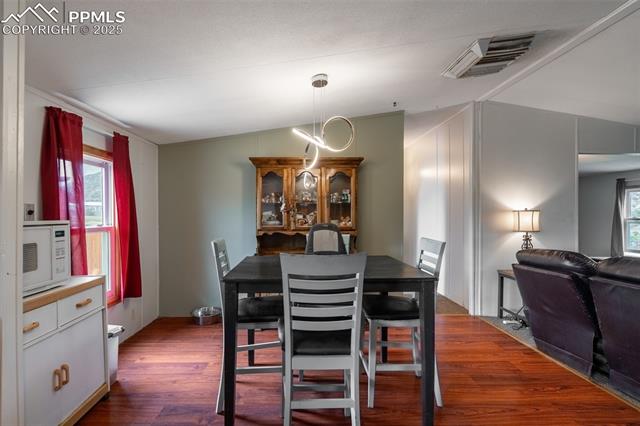 10 Ridgeway Court Florence, CO 81226 - Photo 10 of 23 Dining area featuring dark wood-type flooring and healthy amount of natural light