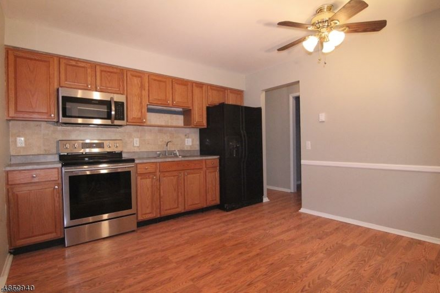 a kitchen with stainless steel appliances granite countertop a refrigerator a stove top oven a sink and dishwasher