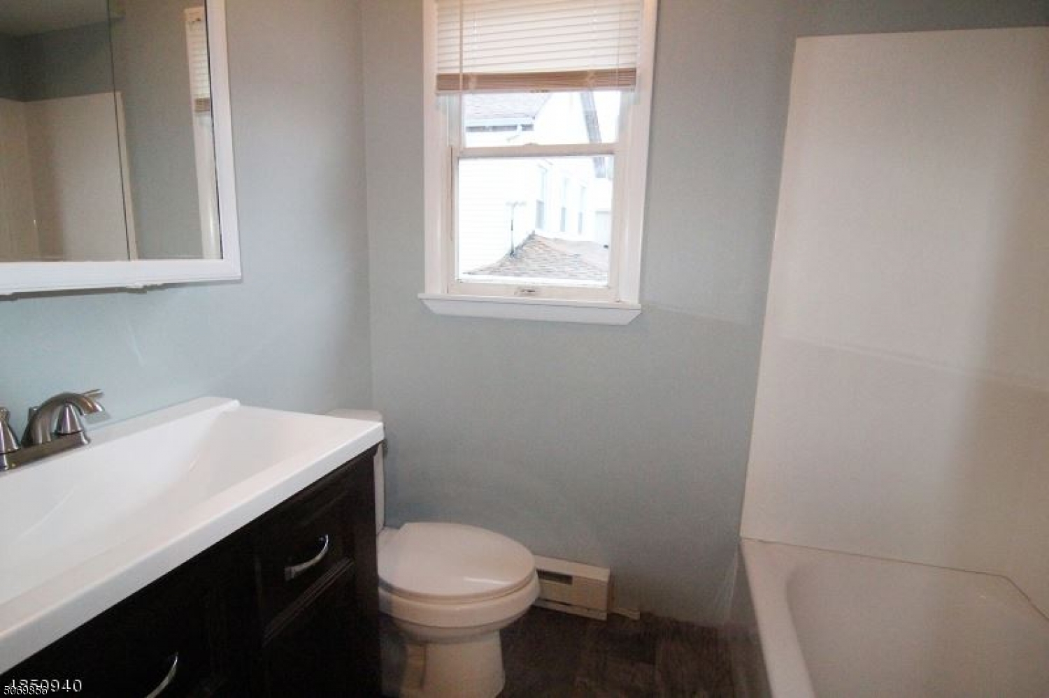 223 Liberty Street, Unit 2 Boonton, NJ 07005 - Photo 2 of 7 a bathroom with a sink toilet and vanity