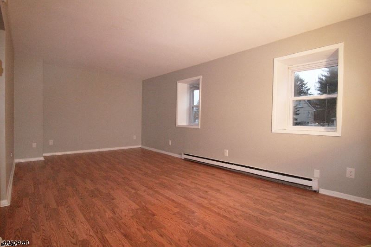 223 Liberty Street, Unit 2 Boonton, NJ 07005 - Photo 7 of 7 a view of an empty room with wooden floor and a window
