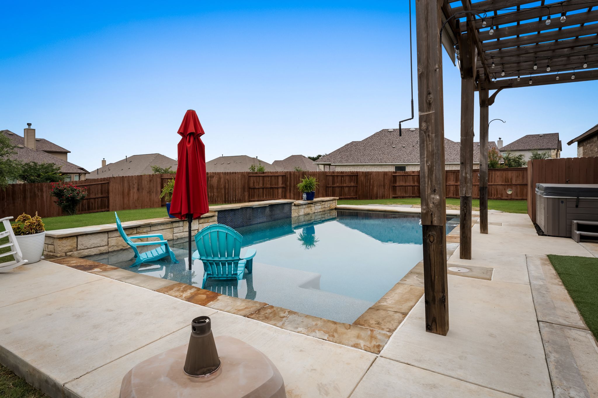 140 Waterloo Cove Georgetown, TX 78628 - Photo 35 of 40 An inviting backyard oasis features a glistening pool, complete with a spa, for ultimate relaxation.