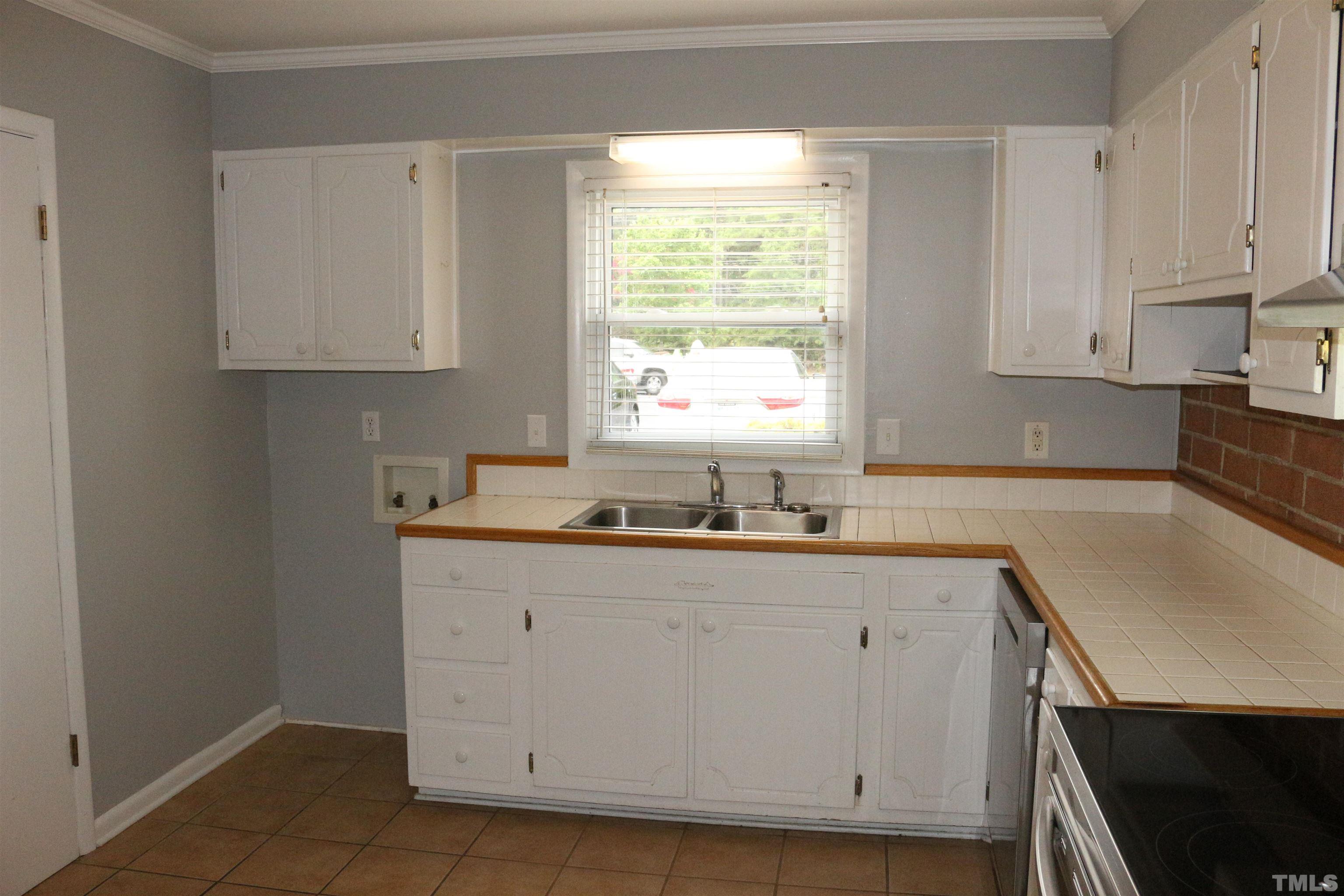 5141 Revere Road, Unit 39 Durham, NC 27713 - Photo 4 of 25 a kitchen with granite countertop white cabinets and sink