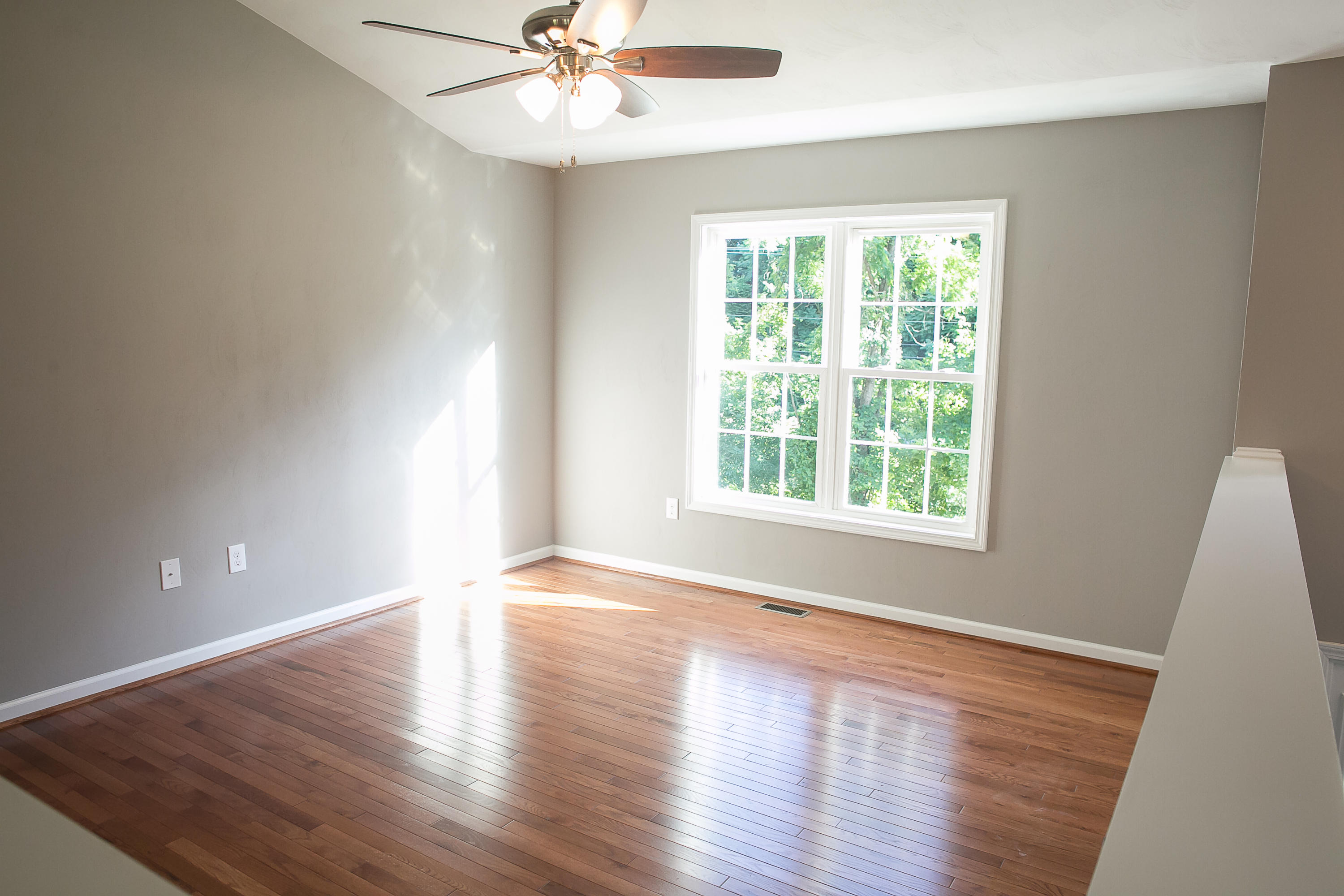 1824 Hardy Road Vinton, VA 24179 - Photo 9 of 13 a view of an empty room with wooden floor and a window