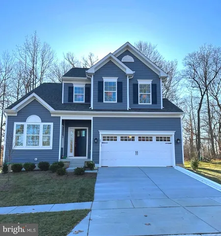 a view of a house with yard and tree s