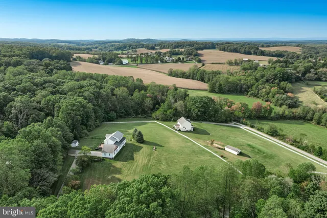an aerial view of a house with yard swimming pool and outdoor seating