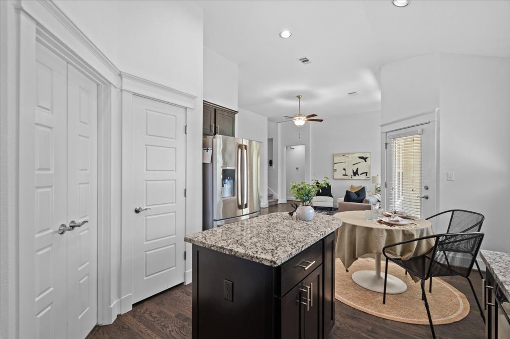 1765 Rowdy Loop, Unit 47 Leander, TX 78641 - Photo 40 of 40 Rich hardwood floors anchor this inviting kitchen featuring granite countertops and an open floor plan.