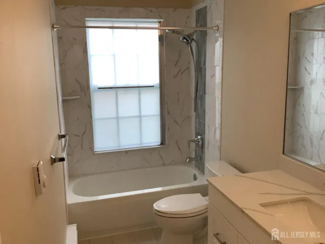 a bath room with a toilet and a bath tub