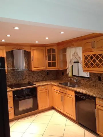 a kitchen with stainless steel appliances granite countertop a sink and cabinets