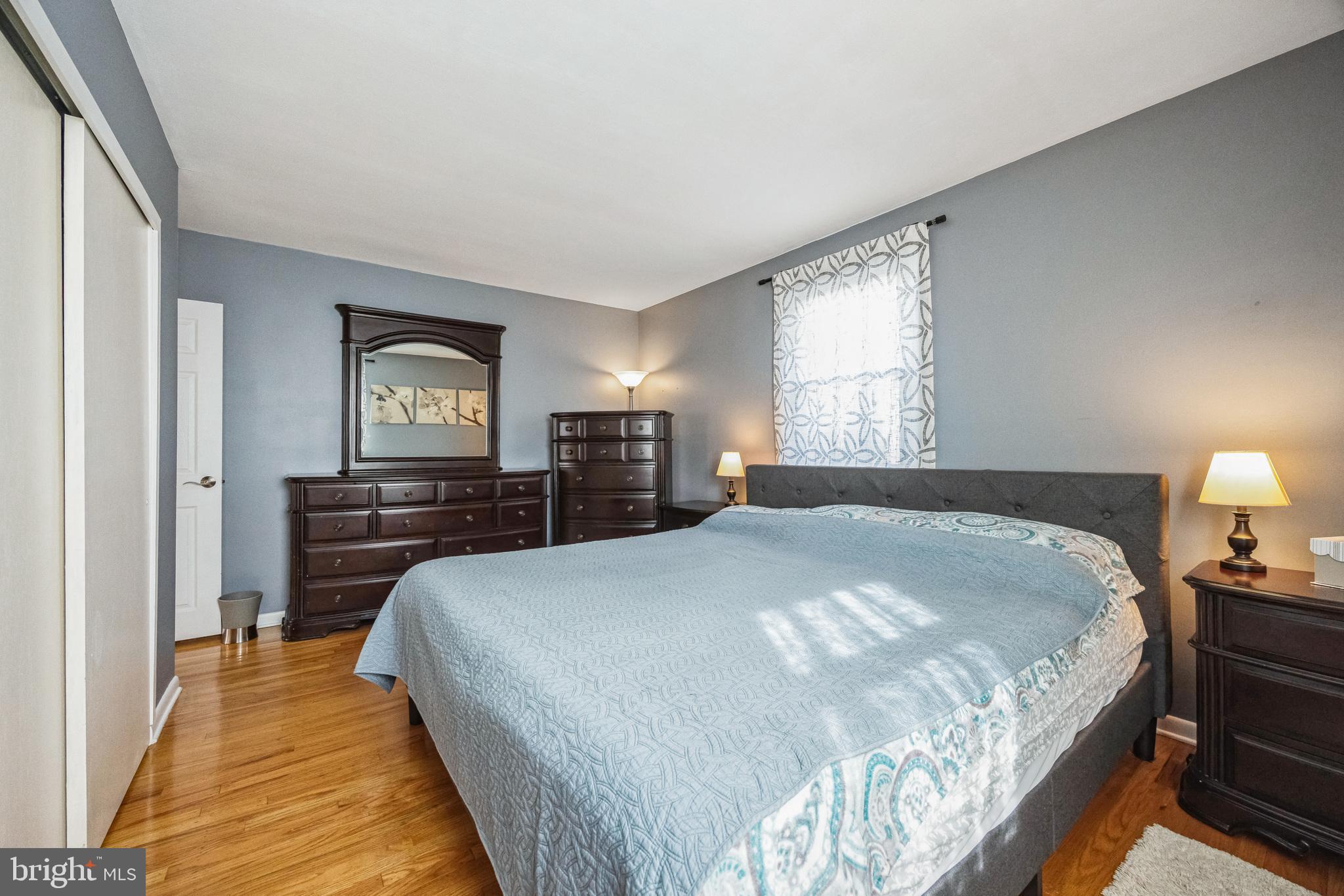 333 Davis Avenue Mount Ephraim, NJ 08059 - Photo 13 of 34 a bedroom with a bed and wooden floor