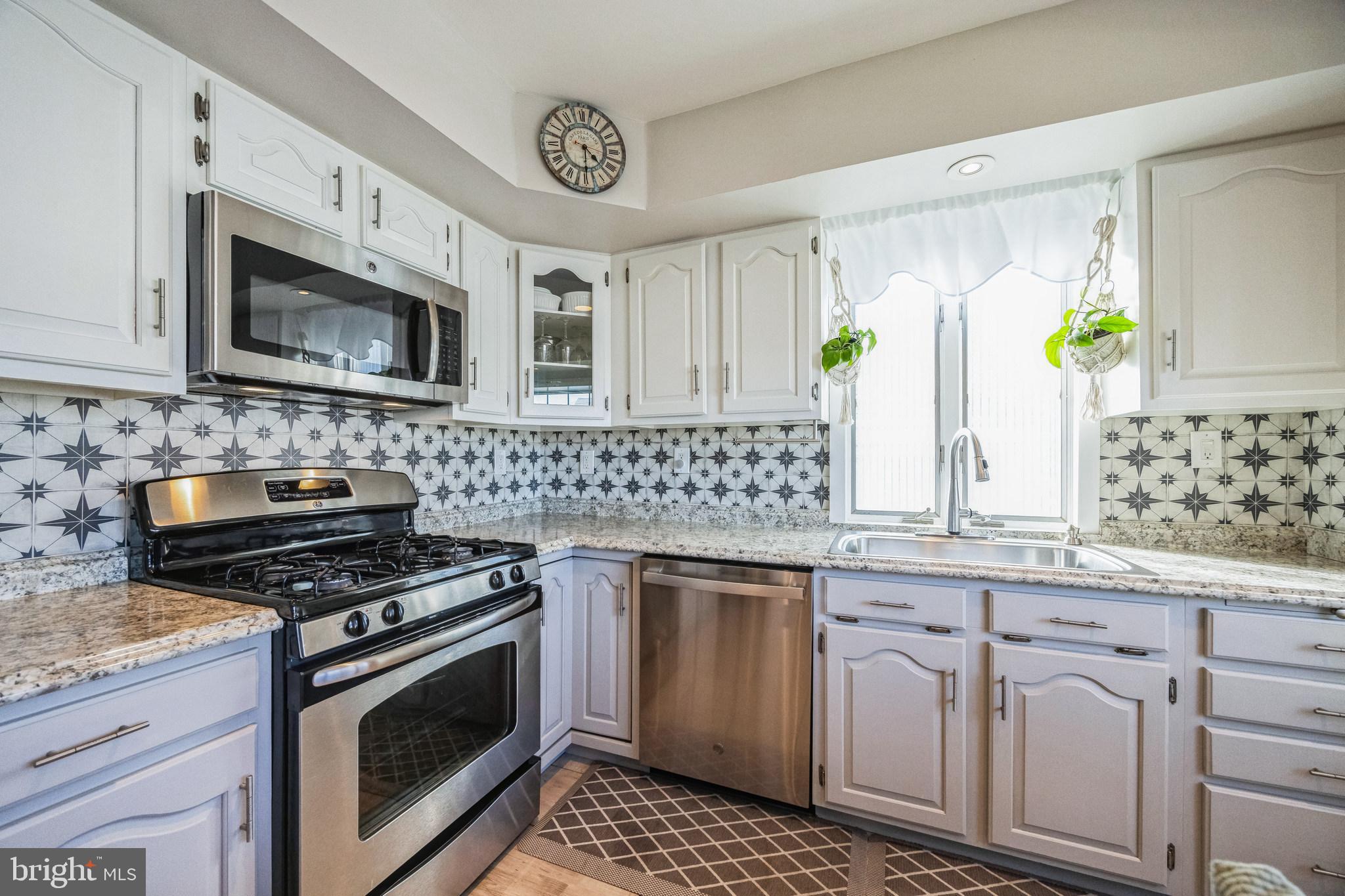 333 Davis Avenue Mount Ephraim, NJ 08059 - Photo 9 of 34 a kitchen with granite countertop white cabinets stainless steel appliances and a counter space