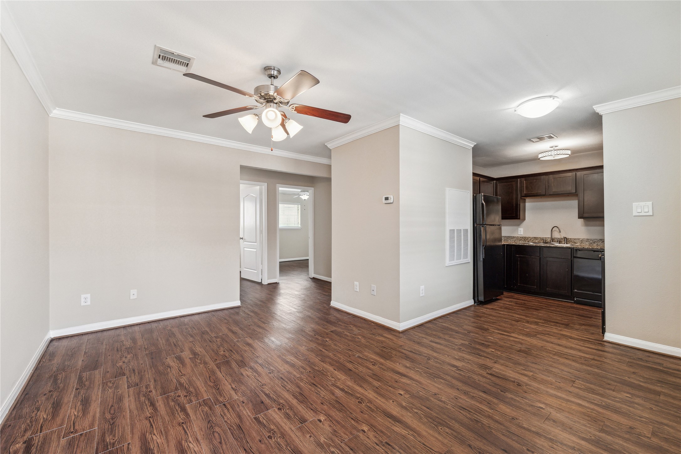 427 West 16th Street, Unit 2 Houston, TX 77008 - Photo 1 of 7 a view of a kitchen with a sink and dishwasher with wooden floor