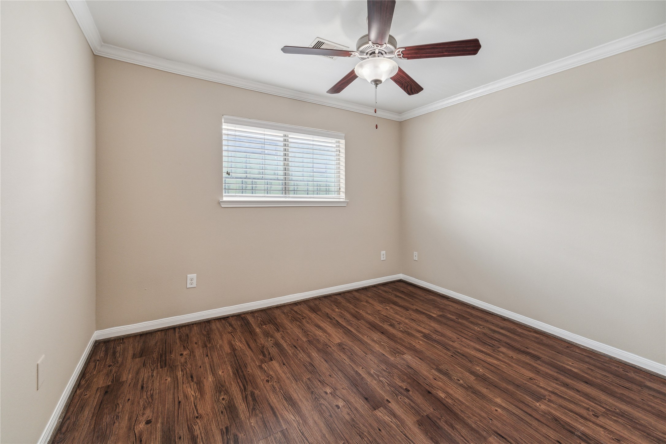 427 West 16th Street, Unit 2 Houston, TX 77008 - Photo 4 of 7 a view of an empty room with wooden floor and a window
