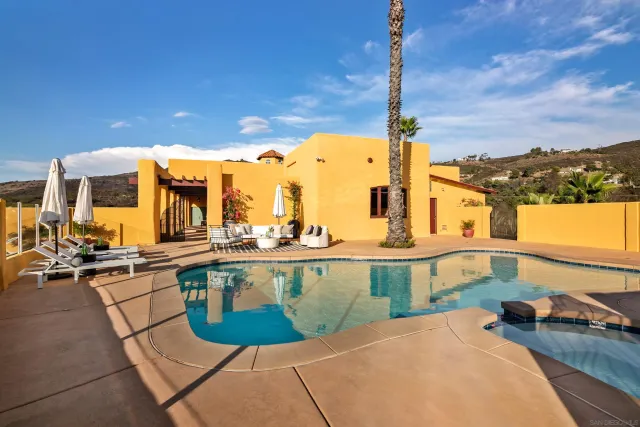 an aerial view of a house with a mountain